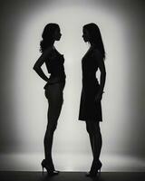 ai généré silhouette de magnifique femmes sur une blanc Contexte. ai génératif photo