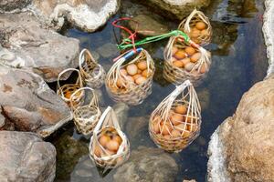 un panier d'œufs pour les touristes qui sont bouillis dans de l'eau chaude minérale et naturelle au parc national de chae son, lampang, thaïlande. photo