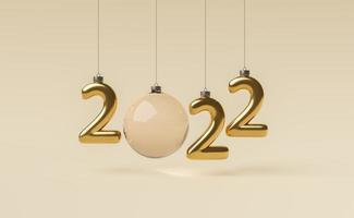 signe du nouvel an 2022 fait avec des ornements de noël dorés photo