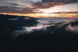le soleil se lève dans la brume et les montagnes le matin