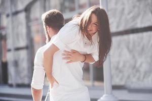 Beautiful happy couple hugging on the city street.lifestyle concept love and romance photo