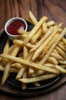 portion de pommes de terre frites snack sur fond de table en bois photo