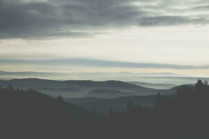 doux brouillard dans le montagnes pendant le coucher du soleil photo