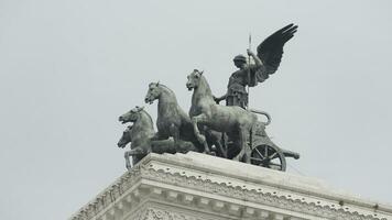 Italie, Rome - juillet 29, 2022. statue avec les chevaux et homme sur bâtiment. action. magnifique composition avec statues sur toit de vieux bâtiment. sculptural statues sur ancien architectural bâtiment sur photo