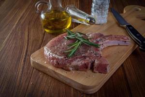 steak de porc cru sur table en bois photo