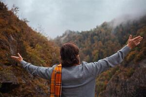 homme regards en haut à montagnes, seul, pensif, automnal paysage, pluvieux mal nuageux temps, seule. Voyage et tourisme. liberté. photo