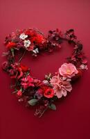 ai généré fleurs arrangé dans une cœur forme sur une rouge Contexte photo