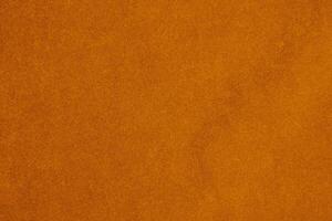 lumière Orange velours en tissu texture utilisé comme Contexte. soie Couleur Safran en tissu Contexte de doux et lisse textile matériel. écrasé velours .luxe Soleil lumière Ton pour soie. photo