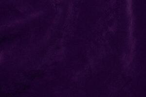 foncé violet velours en tissu texture utilisé comme Contexte. violet Couleur violet en tissu Contexte de doux et lisse textile matériel. écrasé velours .luxe foncé Ton pour soie. photo