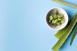 tranches d'aloe vera et feuilles vue de dessus sur fond bleu avec espace de copie photo