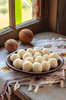 ai généré sucré élégance beijinho noix de coco truffes sur une à motifs folkloriques nappe de table photo