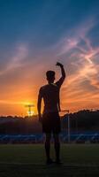 ai génératif football joueur sur une Football champ formation à le coucher du soleil photo