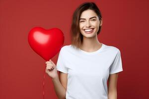 ai généré Jeune brunette femme avec cœur ballon dans le main, portant Bella Toile blanc chemise maquette, rouge Contexte. valentines journée ou anniversaire conception T-shirt modèle, impression présentation. photo