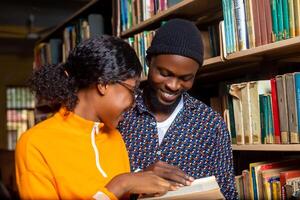 excité haute école élèves en train de lire dans le bibliothèque photo