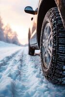 ai généré fermer image de une voiture pneus sur le route dans l'hiver. photo