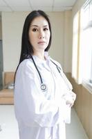 portrait d'une femme médecin intelligente avec un stéthoscope debout à la réception de l'hôpital. photo