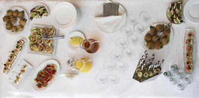 nourriture pour une buffet sur le table Haut voir. collations. une de fête table avec vaisselle et boissons. photo