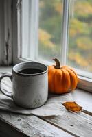 ai généré tasse de café et citrouille sur le rebord de fenêtre dans l'automne. photo