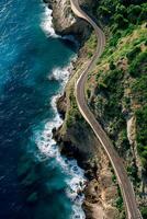 ai généré aérien vue capture enroulement route étreindre le littoral. le route est étroit et pavé, avec visible voie marquages ai généré photo