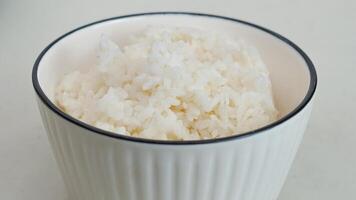 blanc riz dans une blanc bol avec baguettes photo