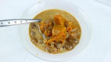 kolak pisang ou banane et citrouille est populaire indonésien dessert fabriqué de banane, citrouille, sucre paume fruit cuit avec noix de coco lait, paume sucre et pandanus feuilles. très populaire pendant ramadan. photo