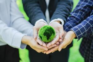 affaires travail en équipe, en portant Terre dans mains. réduire global chauffage environnement journée collaborer à créer vert affaires et csr préservation dans le avenir. la coopération pour durabilité enregistrer monde photo