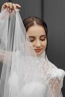 portrait de une Jeune la mariée dans une blanc mariage robe avec manches. professionnel coiffure et Naturel se maquiller. mariage concept photo