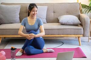 femmes sont élongation, à maison, et aptitude femmes exercice ou faire yoga dans leur chambre pour santé et bien-être une en bonne santé, calme femelle la personne formation ou travail sur le maison sol. photo