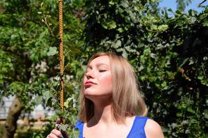 portrait de une fille dans une bleu robe sur Contexte de vert tonnelle de lierre. photo