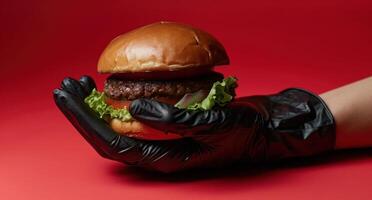 ai généré une main détient une noir gant plus de une Hamburger photo