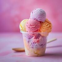 ai généré une petit clair Plastique tasse rempli avec multicolore boules de la glace crème sur rose Contexte avec une en bois cuillère sur le côté. génératif ai. photo