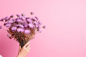 ai généré rose horizontal Contexte avec une bouquet de lilas asters dans femelle mains. généré par artificiel intelligence photo