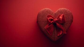 ai généré rouge boîte dans le forme de une cœur avec une arc sur une minimaliste rouge Contexte photo