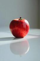 ai généré une rouge Pomme séance sur Haut de une blanc table photo