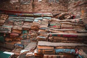 ancien livres dans désarroi dans vaguement allumé, confortable pièce avec chaud lumière du soleil diffusion par fenêtre photo