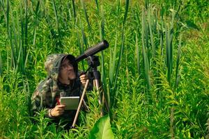 homme faune chercheur fait du champ observation avec une repérage portée photo