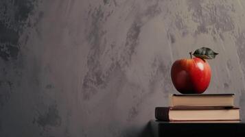 ai généré une rouge Pomme séance sur Haut de une empiler de livres sur Haut de une noir table suivant à une gris mur photo