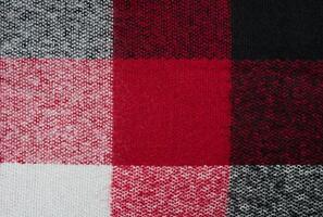 le texture de une chaud de laine foulard. à carreaux écharpe pour femmes. abstrait Contexte. sélectif se concentrer. photo