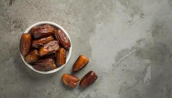 ai généré une bol de juteux Rendez-vous sur une texturé gris surface, capturer le essence de Ramadan. idéal pour iftar invitations ou Ramadan salutations. Haut voir, plat poser. photo