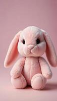 ai généré photo de doux jouet lapin bébé rose lapin sur rose Contexte farci animal les enfants ses une fille bébé pièce bébé douche. ai généré