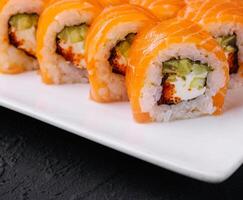 Sushi rouleau crême Philadelphia avec Saumon et caviar sur assiette photo