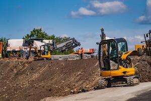 les fouilles travail sur le construction de rural routes. lourd spécial machinerie. route réparation concept. photo