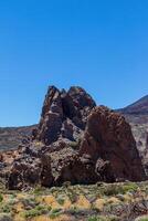 isolé Roche formation contre une clair bleu ciel dans une Dénudé désert paysage dans le teide, nationale parc, Tenerife photo