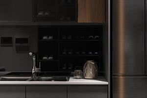une compact cuisine avec noir armoires et blanc compteur hauts. photo