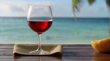 ai généré verre de rouge du vin sur une tropical plage photo