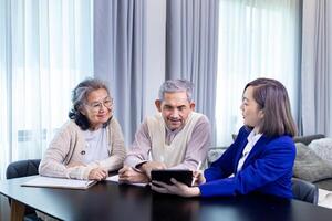 asiatique Sénior couple avoir Conseil de avocat sur légal financier Contrat et Assurance santé se soucier avantage pour retraite Accueil visite un service professionnel consultant photo