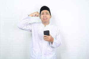 triste musulman asiatique homme pleurs avec en portant téléphone photo