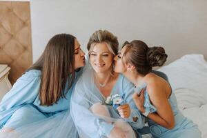 une magnifique la mariée et sa demoiselles d'honneur sont ayant amusement dans le Matin. mariage fête. content les filles à leur meilleur amis mariage. une magnifique et élégant la mariée avec sa demoiselles d'honneur photo