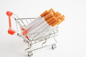 cigarette dans achats Chariot, coût, commerce, commercialisation et production, non fumeur concept. photo