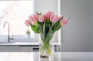 ai généré rose tulipes arrangé dans une verre vase, orner une cuisine comptoir. photo